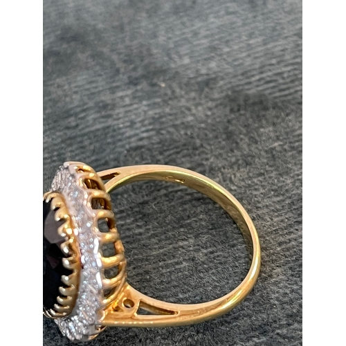 514 - 9ct yellow gold and diamond ring with a possible tourmaline