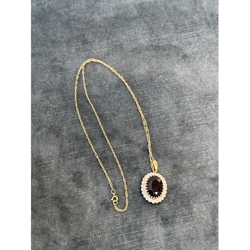 515 - 9ct yellow gold and diamond necklace and chain, with a possible tourmaline