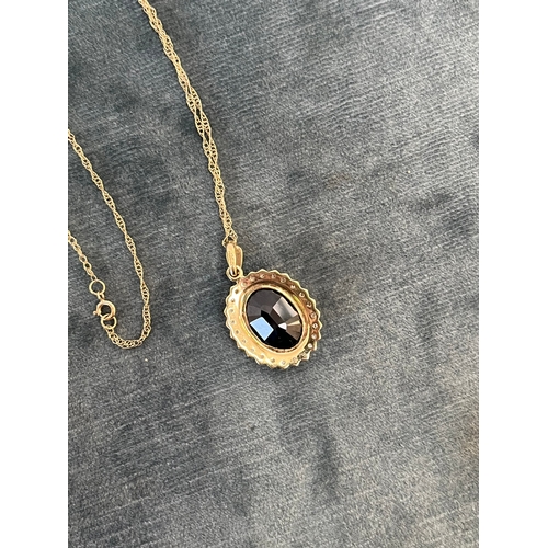 515 - 9ct yellow gold and diamond necklace and chain, with a possible tourmaline