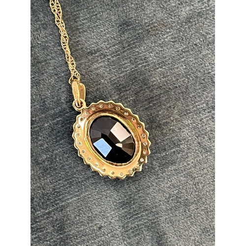 515 - 9ct yellow gold and diamond necklace and chain, with a possible tourmaline