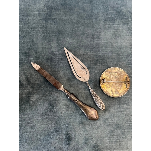 539 - Silver coin brooch, silver bookmark and silver handled file