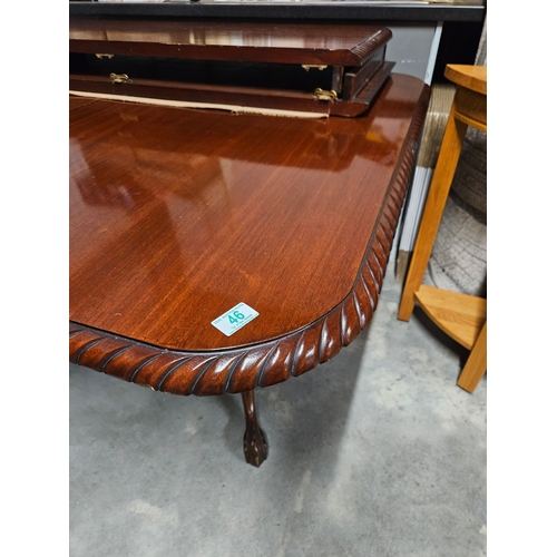 46 - Extending pie crust dining table with two extra leaves. With ball and claw feet.