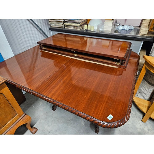 46 - Extending pie crust dining table with two extra leaves. With ball and claw feet.