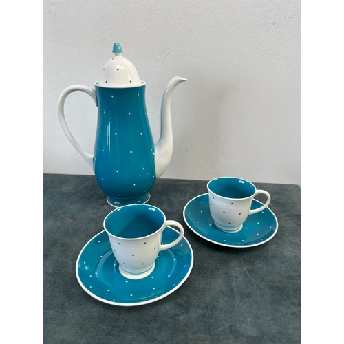 320 - Susie Cooper blue and white polka dot teapot, two cups and saucers and spare saucers