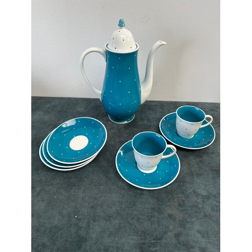 320 - Susie Cooper blue and white polka dot teapot, two cups and saucers and spare saucers