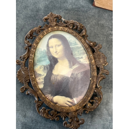 296 - Cased painted egg and reproduction of Mona Lisa in brass frame