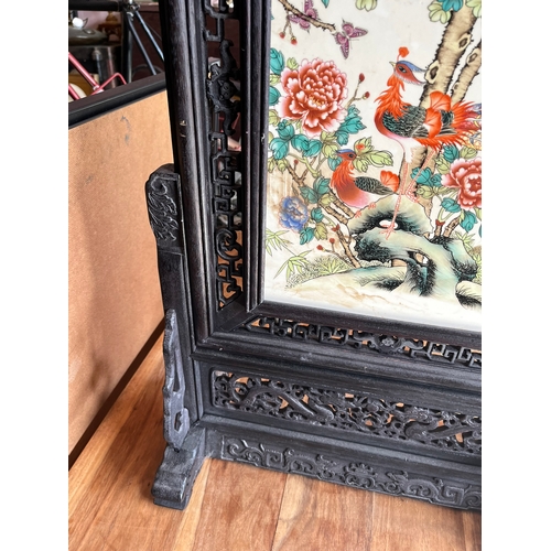 19 - Oriental carved hardwood screen with porcelain panel