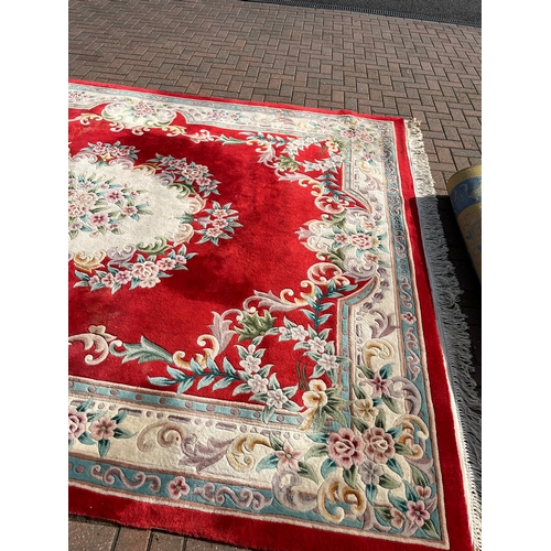 79 - Large red oriental style wool rug 

275cm x 370cm