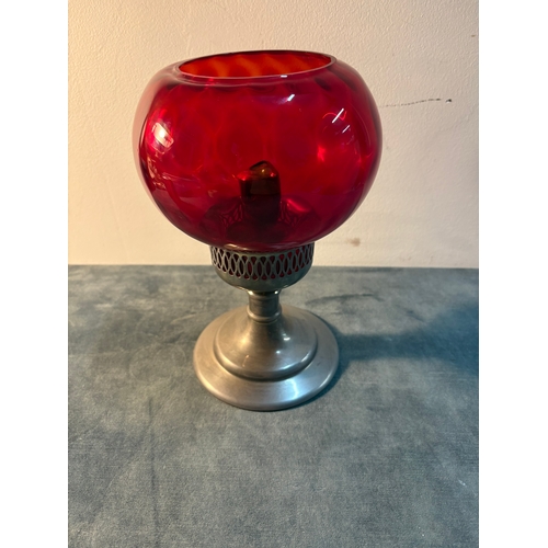 Small red glass and metal candlestick