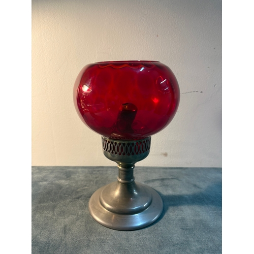 Small red glass and metal candlestick