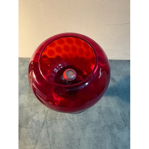 Small red glass and metal candlestick