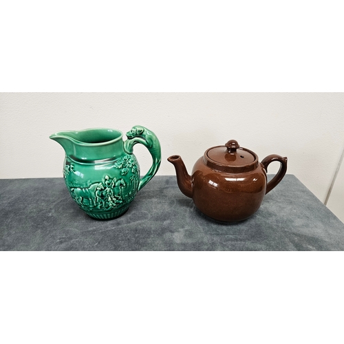 277 - Brown pottery teapot and Wedgwood Majolica green hunting scene jug