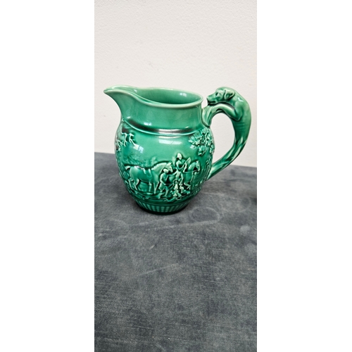 277 - Brown pottery teapot and Wedgwood Majolica green hunting scene jug