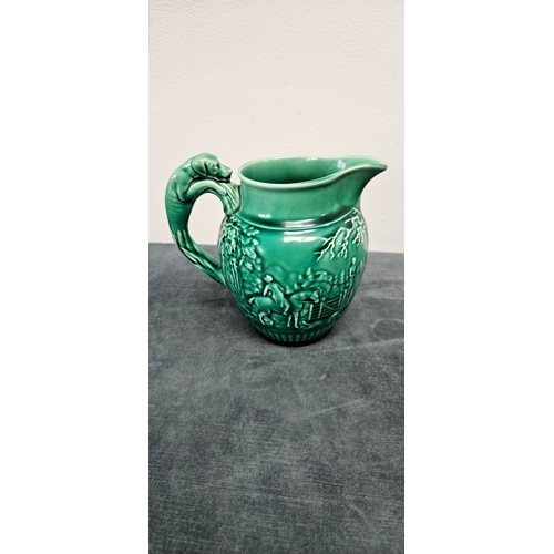 277 - Brown pottery teapot and Wedgwood Majolica green hunting scene jug