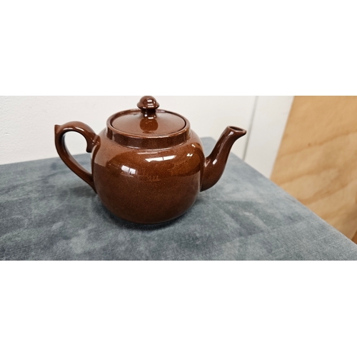 277 - Brown pottery teapot and Wedgwood Majolica green hunting scene jug