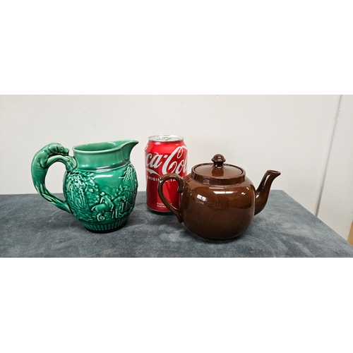 277 - Brown pottery teapot and Wedgwood Majolica green hunting scene jug