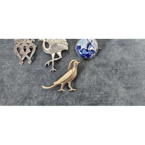 562 - 4 x Silver brooches including delft and birds