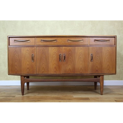 A mid century g Plan four door sideboard raised on hairpin legs