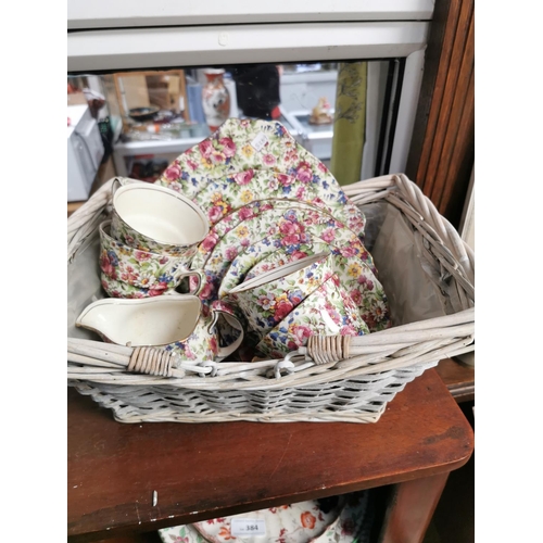 385 - WICKER BASKET OF ROYAL WINTON CUPS AND SAUCERS