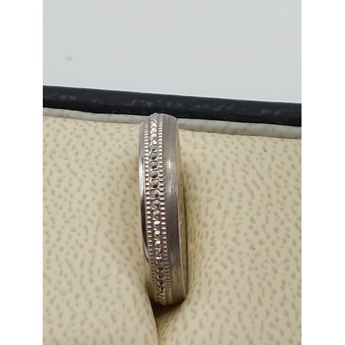 346 - 18ct WHITE GOLD DECORATIVE BAND. SIZE ‘N’. 
WEIGHT 5.8gms.  HALLMARKED .750