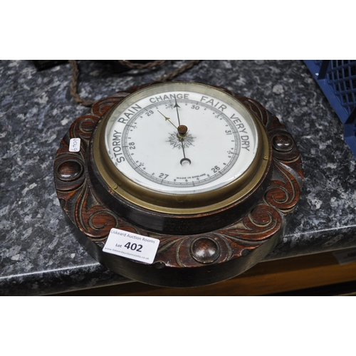 402 - OAK CARVED ROUND WALL BAROMETER