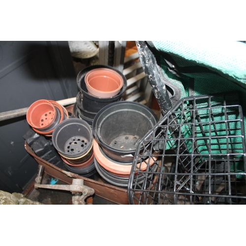 283 - QUANTITY OF PLASTIC MIXED SIZE PLANT POTS IN A GALVANISED PLANTER