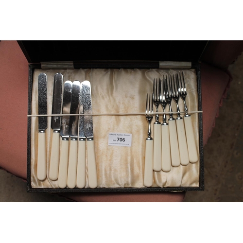 706 - CASE OF FAUX IVORY HANDLED KNIVES AND FORKS