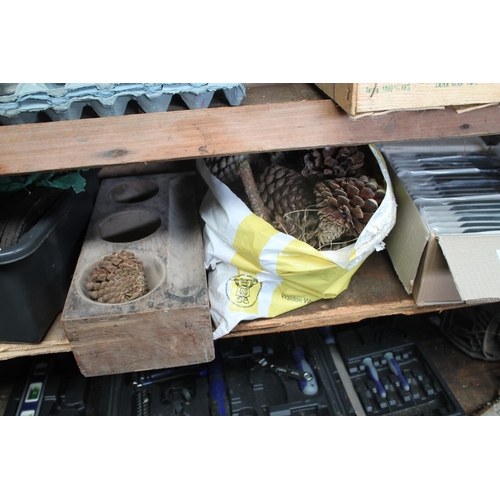 127 - LARGE BAG OF PINE CONES AND WOODEN MYSTERY ITEM