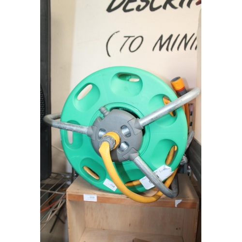 58 - YELLOW GARDEN HOSE ON REEL