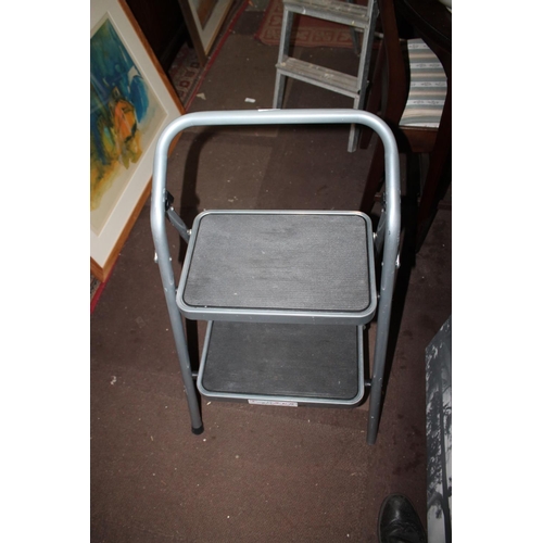 594 - PAIR OF GREY METAL FOLDING STEPLADDERS