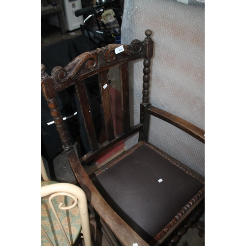 645 - A SINGLE WING BACK DARKWOOD ARM CHAIR