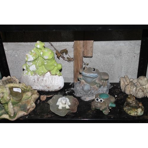 31 - A SHELF OF FROG GARDEN ORNAMENTS INCLUDING CONCRETE AND SPRINKLER