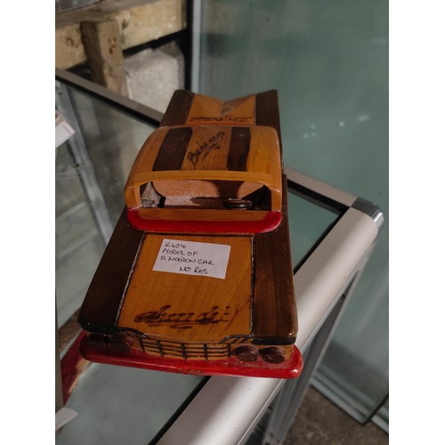 504 - WOODEN MODEL OF A CAR. POSSIBLY A 1950'S BUICK