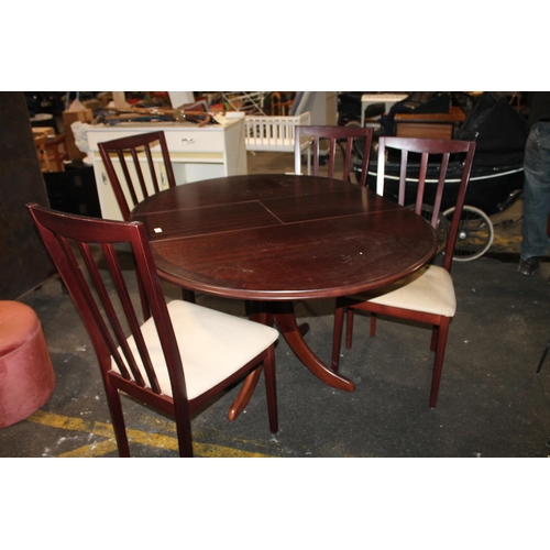 607 - DARK WOOD EXTENDING TABLE AND SET OF FOUR CHAIRS