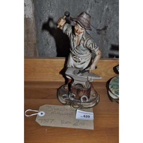 620 - A BLACKSMITH FIGURE