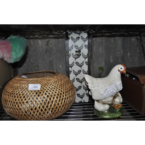 241 - DECORITIVE BOTTLE CASE WICKER LAMP WITH FITTINGS AND A PORCELAIN CHICKEN