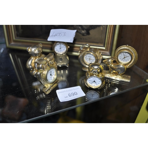 690 - 6 MINIATURE GILT CLOCKS
