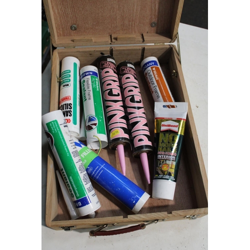 30 - WOODEN DOVE-TAILED CARRY BOX CONTAINING VARIOUS BUILDING ADHESIVES INC PINK GRIP, SILICONE SEALANT, ... 