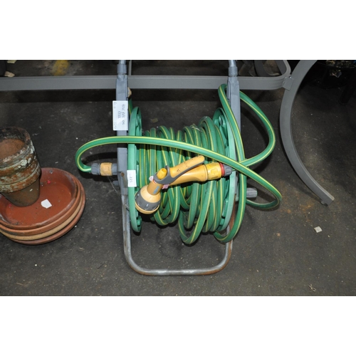 225 - LARGE GARDEN HOSE ON REEL WITH SPRAY HEAD AND FITTINGS