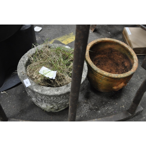 228 - A CONCRETE LION HEAD PATTERNED GARDEN POT PLUS A TERACOTTA POT FLEUR DI LIS PATTERN