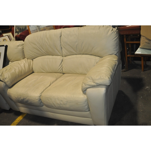 1256 - A SOFT ALABASTER COLOURED LEATHER TWO SEATER SOFA