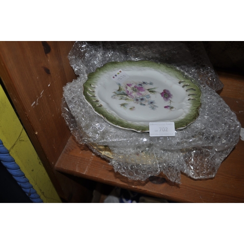 702 - A VINTAGE SET OF PLATES WITH A FLORAL DESIGN