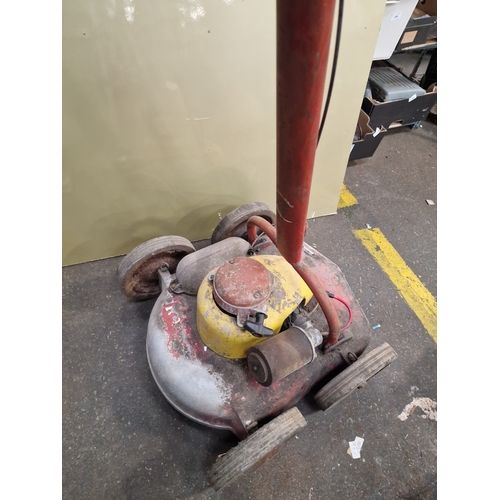 110 - A Vintage Petrol-Powered Rotary LawnmowerThis vintage petrol-powered rotary lawnmower is of mid-20... 
