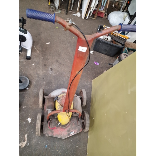 110 - A Vintage Petrol-Powered Rotary LawnmowerThis vintage petrol-powered rotary lawnmower is of mid-20... 