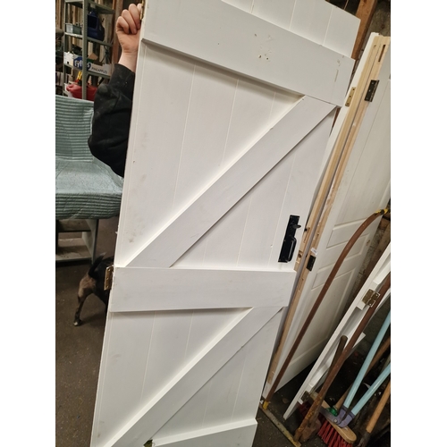 62 - A Pair of Reclaimed White-Painted Timber Ledged and Braced DoorsA matching pair of reclaimed timbe... 
