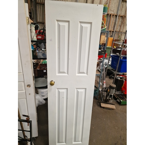 64 - A Four-Panel Painted Timber Interior Door with Brass-Finish FittingsA traditional style interior d... 