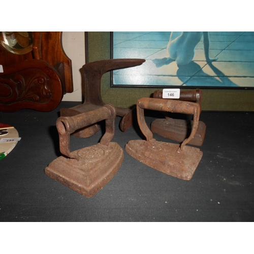 146 - 3 vintage cast irons and cobblers last