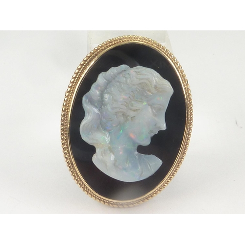 108 - Cameo brooch with carved opal portrait of a woman upon onyx in 9ct gold.