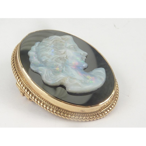 108 - Cameo brooch with carved opal portrait of a woman upon onyx in 9ct gold.