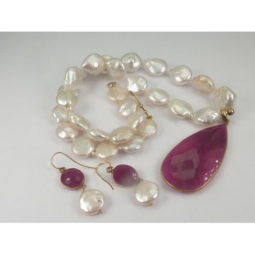 115 - Ruby and baroque pearl necklace with large faceted drop with earrings, 18ct gold mounts.